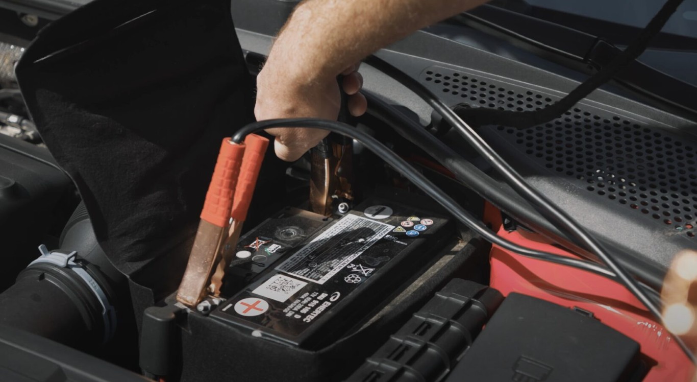 Roadside assistance technician providing battery jump start service in Cerritos, CA